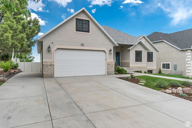 5718 W Silver Rose Cir S, Herriman, UT 84096 - view of front of property with stucco siding, driveway, brick siding, stone siding, and a shingled roof