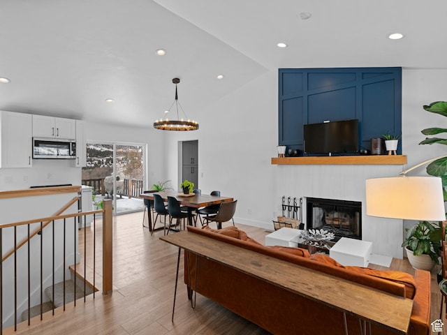 8375 E Lake Pines Dr Unit 212, Heber City, UT 84032 - living room with a chandelier, light wood-type flooring, a fireplace, recessed lighting, and vaulted ceiling
