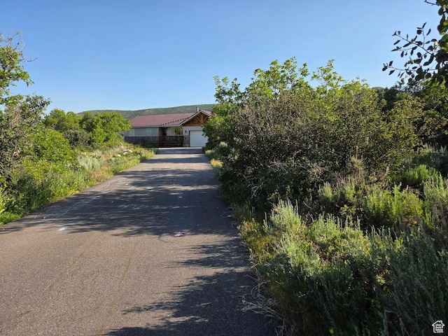 8375 E Lake Pines Dr Unit 212, Heber City, UT 84032 - view of property hidden behind natural elements with driveway and a garage