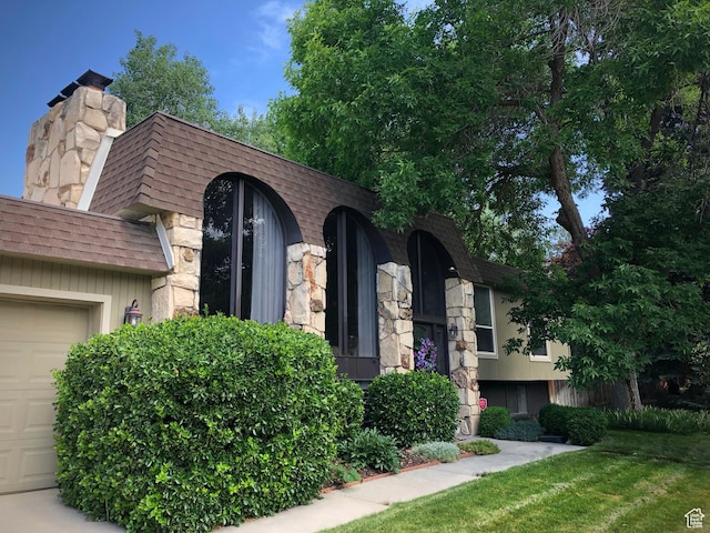 3411 E Enchanted View Dr S, Cottonwood Heights, UT 84121 - front facade featuring a garage, roof with shingles, stone siding, and a chimney