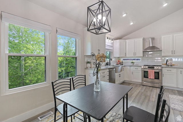 10787 S Pine Shadow Rd, South Jordan, UT 84009 - kitchen with appliances with stainless steel finishes, wall chimney range hood, tasteful backsplash, white cabinetry, and vaulted ceiling
