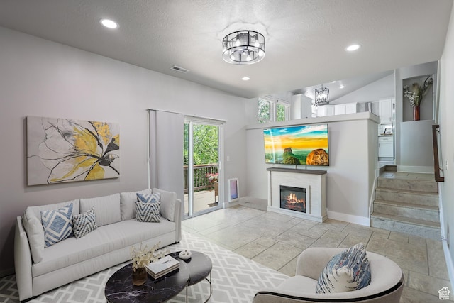 10787 S Pine Shadow Rd, South Jordan, UT 84009 - living area with a chandelier, recessed lighting, a glass covered fireplace, a textured ceiling, and stairway