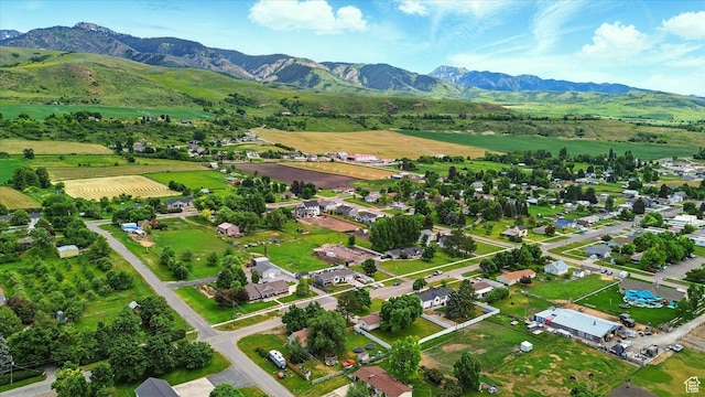 155 N 200 E, Richmond, UT 84333 - aerial overview of property's location featuring a mountainous background and rural landscape