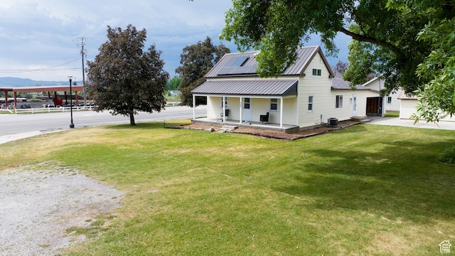 297 S 200 W, Richmond, UT 84333 - country-style home featuring a porch, solar panels, a front yard, and a metal roof
