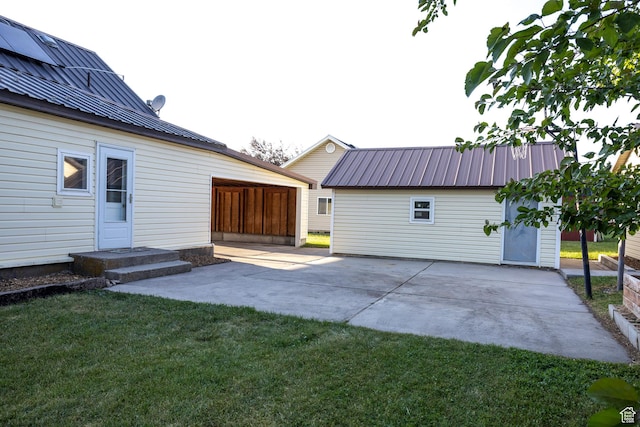 297 S 200 W, Richmond, UT 84333 - back of property featuring a metal roof, a patio, and a lawn