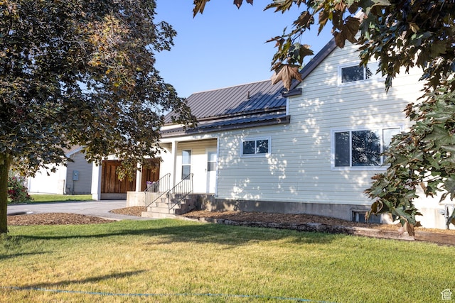 297 S 200 W, Richmond, UT 84333 - view of front facade featuring a front yard, a metal roof, and entry steps