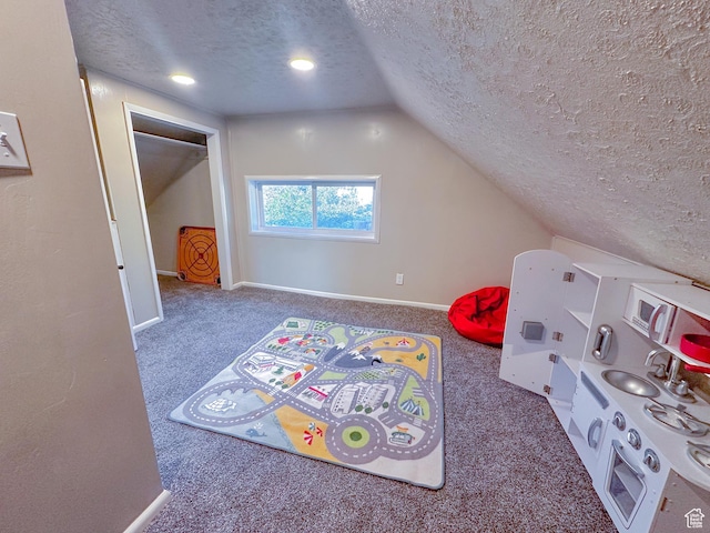 297 S 200 W, Richmond, UT 84333 - playroom featuring a textured ceiling, carpet flooring, and vaulted ceiling