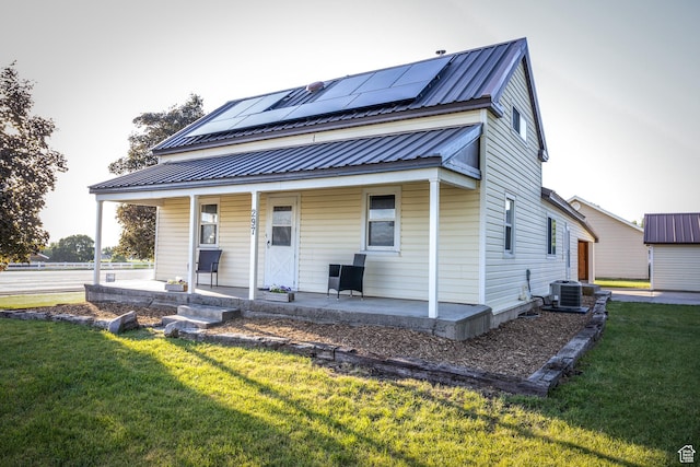 297 S 200 W, Richmond, UT 84333 - view of front of house with a porch, solar panels, a front yard, and a metal roof