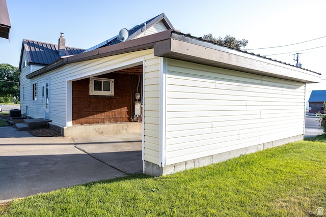 297 S 200 W, Richmond, UT 84333 - view of side of home with driveway, a metal roof, a lawn, and a chimney