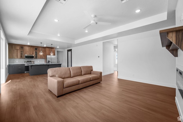 2154 S Bluff Dr, Cedar City, UT 84720 - living area with a tray ceiling, recessed lighting, wood finished floors, and a ceiling fan
