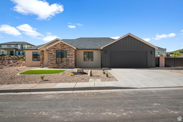 2154 S Bluff Dr, Cedar City, UT 84720 - view of front of property featuring an attached garage, concrete driveway, board and batten siding, stone siding, and a shingled roof