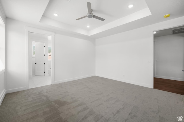 2154 S Bluff Dr, Cedar City, UT 84720 - unfurnished bedroom with a raised ceiling, carpet floors, recessed lighting, connected bathroom, and a ceiling fan