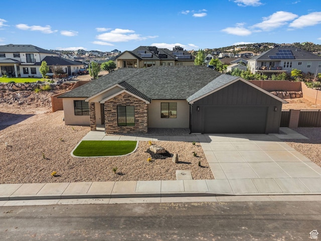 2154 S Bluff Dr, Cedar City, UT 84720 - view of front of home featuring a residential view, roof with shingles, a garage, driveway, and board and batten siding