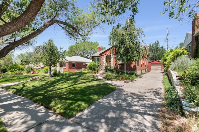 2359 E Bryan Ave S, Salt Lake City, UT 84108 - view of front of home featuring an outbuilding, a front lawn, a detached garage, and brick siding