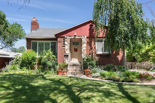 2359 E Bryan Ave S, Salt Lake City, UT 84108 - view of front facade featuring brick siding, a front lawn, a chimney, and entry steps