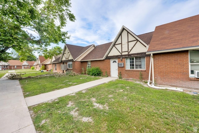 710 N 800 W Unit 11, Salt Lake City, UT 84116 - tudor-style house featuring brick siding, a front lawn, and roof with shingles