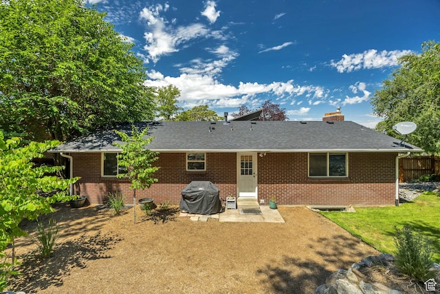 26 N 325 E, Farmington, UT 84025 - back of property with brick siding, a patio area, roof with shingles, and a chimney
