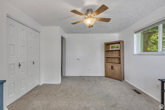 26 N 325 E, Farmington, UT 84025 - unfurnished bedroom featuring carpet floors, a closet, a textured ceiling, and a ceiling fan