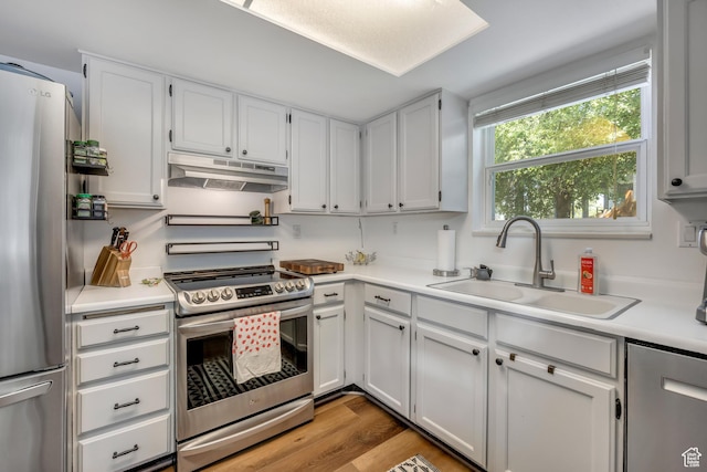 26 N 325 E, Farmington, UT 84025 - kitchen featuring stainless steel appliances, under cabinet range hood, light countertops, white cabinets, and light wood-type flooring