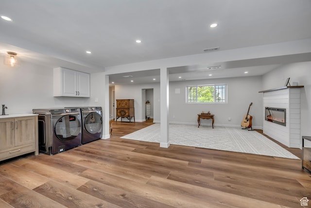 26 N 325 E, Farmington, UT 84025 - laundry area with washing machine and clothes dryer, light wood-type flooring, recessed lighting, and a glass covered fireplace