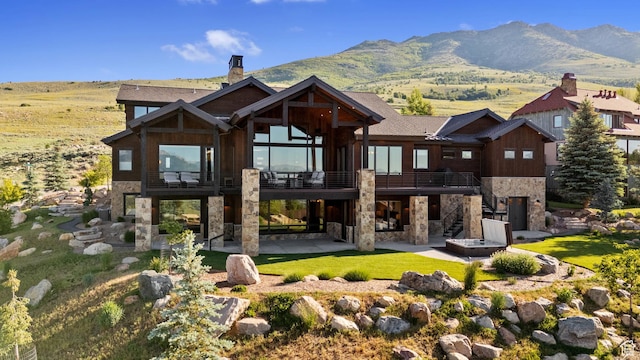 3911 N Zermatt St, Eden, UT 84310 - back of house featuring stone siding, a patio area, a chimney, and stairway