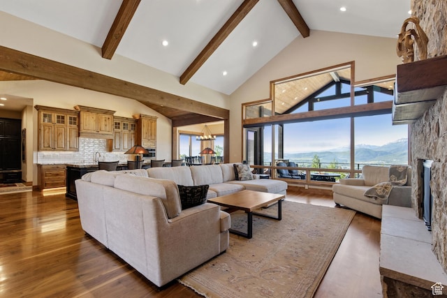 3911 N Zermatt St, Eden, UT 84310 - living area with beam ceiling, dark wood finished floors, a mountain view, high vaulted ceiling, and recessed lighting