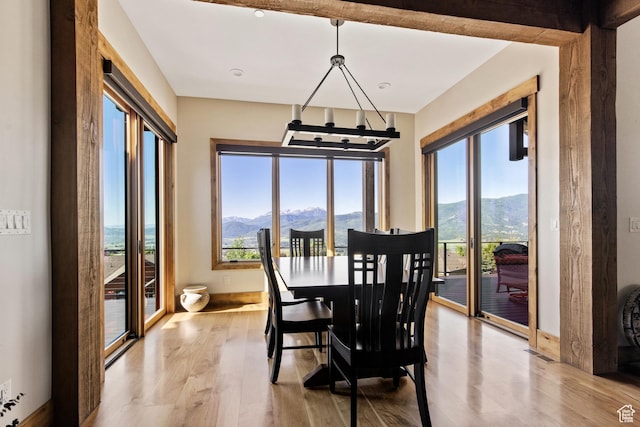 3911 N Zermatt St, Eden, UT 84310 - dining room featuring a mountain view, light wood-style flooring, and a chandelier