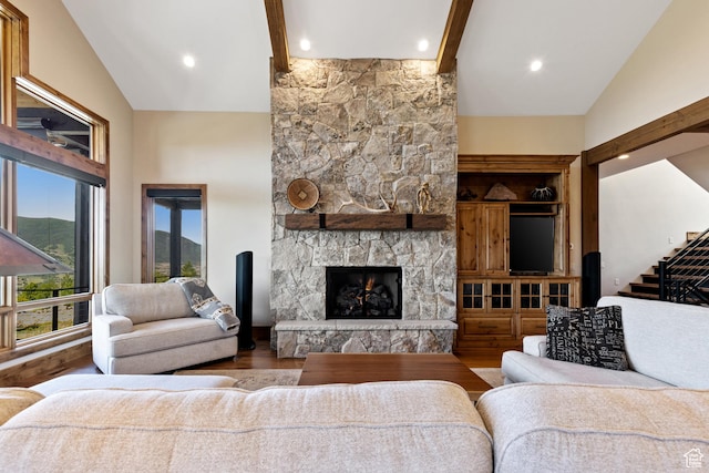 3911 N Zermatt St, Eden, UT 84310 - living room featuring beam ceiling, wood finished floors, high vaulted ceiling, a fireplace, and stairs