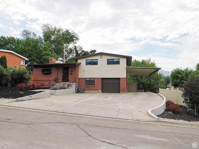 4601 S Creekview Cir, Murray, UT 84107 - tri-level home featuring brick siding, driveway, a garage, and a chimney