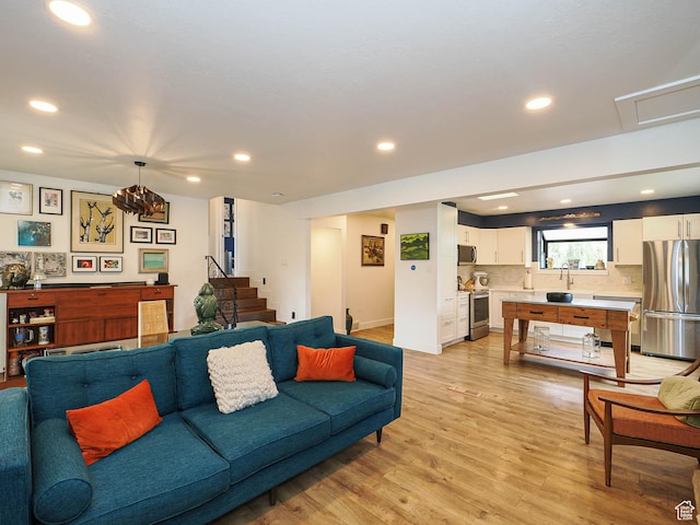 4601 S Creekview Cir, Murray, UT 84107 - living area with recessed lighting, light wood finished floors, and stairway