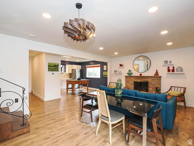 4601 S Creekview Cir, Murray, UT 84107 - dining room with recessed lighting, light wood-style floors, a fireplace, and stairway