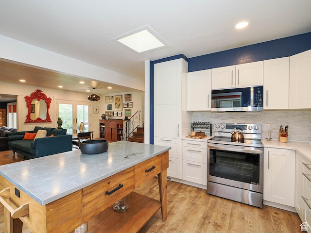 4601 S Creekview Cir, Murray, UT 84107 - kitchen with stainless steel appliances, white cabinetry, and recessed lighting