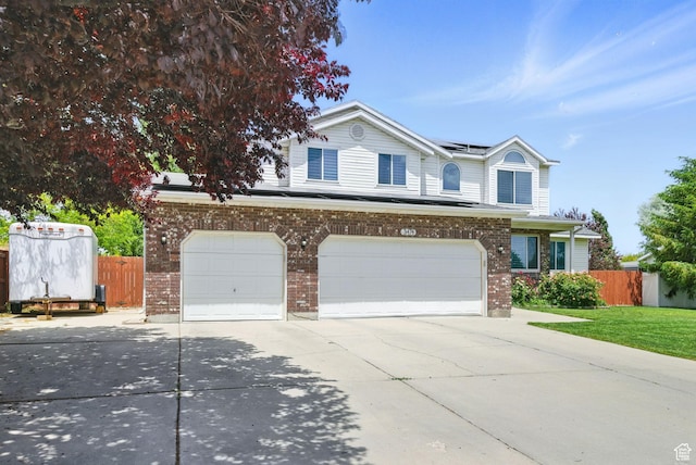 3474 W 7520 S, West Jordan, UT 84084 - view of front of home with concrete driveway, an attached garage, solar panels, and brick siding