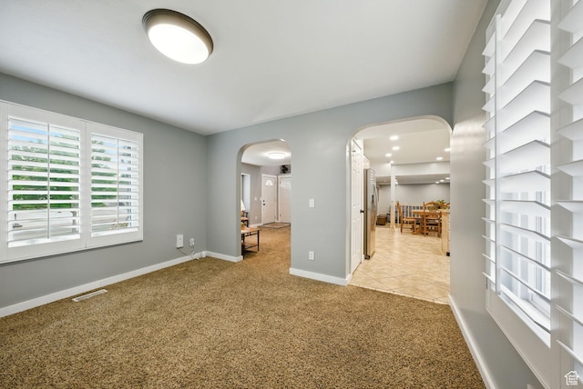 3474 W 7520 S, West Jordan, UT 84084 - empty room featuring arched walkways and light colored carpet