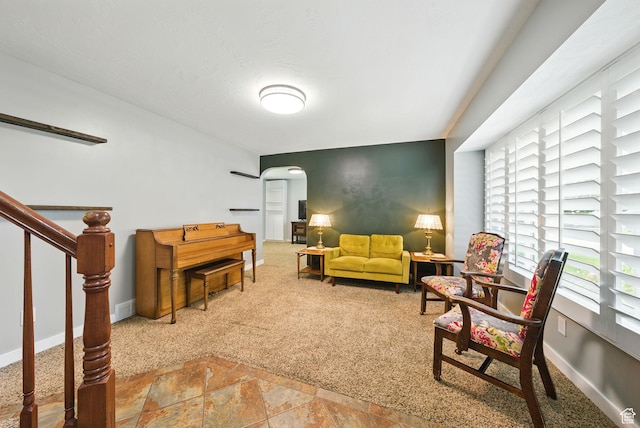 3474 W 7520 S, West Jordan, UT 84084 - carpeted living room featuring arched walkways, stairs, and stone finish flooring