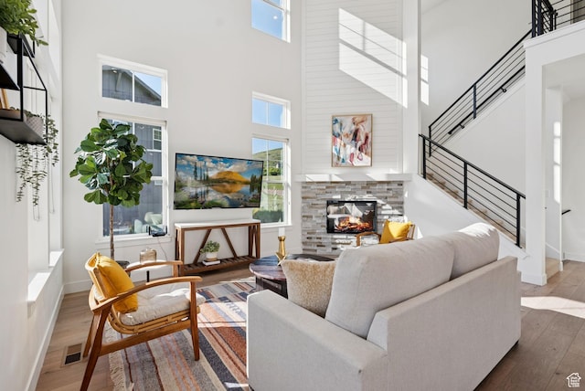 12756 N Belaview Way, Hideout, UT 84036 - living area featuring a high ceiling, wood finished floors, and a stone fireplace