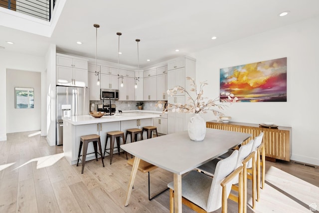12756 N Belaview Way, Hideout, UT 84036 - dining area with light wood finished floors, recessed lighting, and radiator