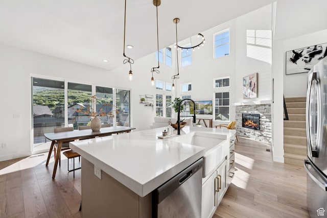 12756 N Belaview Way, Hideout, UT 84036 - kitchen with dishwasher, a fireplace, light wood finished floors, refrigerator, and white cabinets