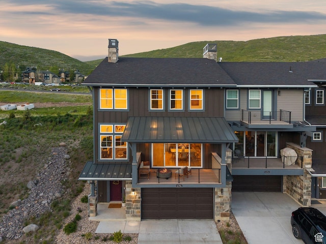 12756 N Belaview Way, Hideout, UT 84036 - rear view of property featuring a chimney, a standing seam roof, a garage, and driveway