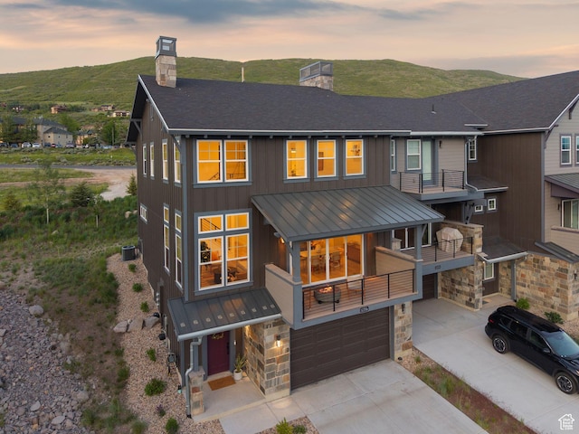 12756 N Belaview Way, Hideout, UT 84036 - view of front facade featuring a chimney, a standing seam roof, a metal roof, and a garage