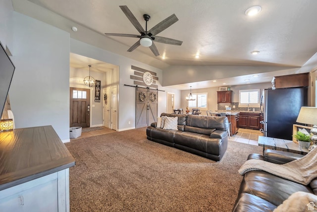 1295 S 4050 W, Syracuse, UT 84075 - living area with a barn door, light carpet, vaulted ceiling, ceiling fan, and recessed lighting