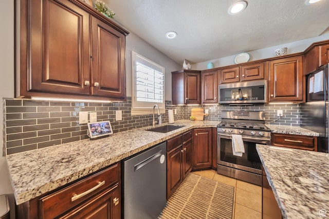 1295 S 4050 W, Syracuse, UT 84075 - kitchen featuring appliances with stainless steel finishes, backsplash, light tile patterned flooring, light stone counters, and recessed lighting