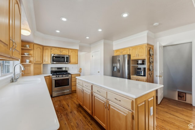 11694 S Stone Crest Cir W, Riverton, UT 84065 - kitchen with appliances with stainless steel finishes, ornamental molding, a center island, wood finished floors, and light countertops