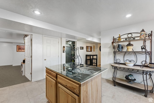 11694 S Stone Crest Cir W, Riverton, UT 84065 - kitchen with dark countertops, light tile patterned floors, a center island, recessed lighting, and light carpet