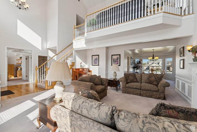 11694 S Stone Crest Cir W, Riverton, UT 84065 - living room featuring a chandelier, a high ceiling, stairs, and carpet