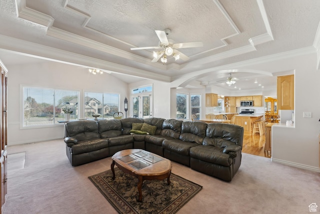 11694 S Stone Crest Cir W, Riverton, UT 84065 - living room with ceiling fan, light colored carpet, arched walkways, a raised ceiling, and ornamental molding