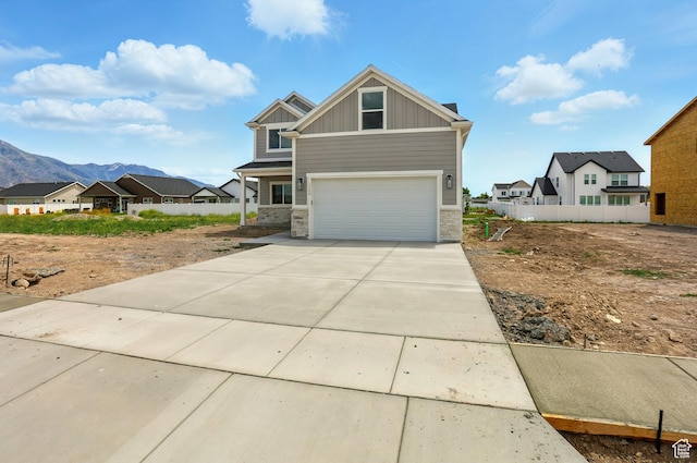 1154 E 1150 S, Garland, UT 84312 - craftsman-style home featuring stone siding, board and batten siding, an attached garage, and concrete driveway