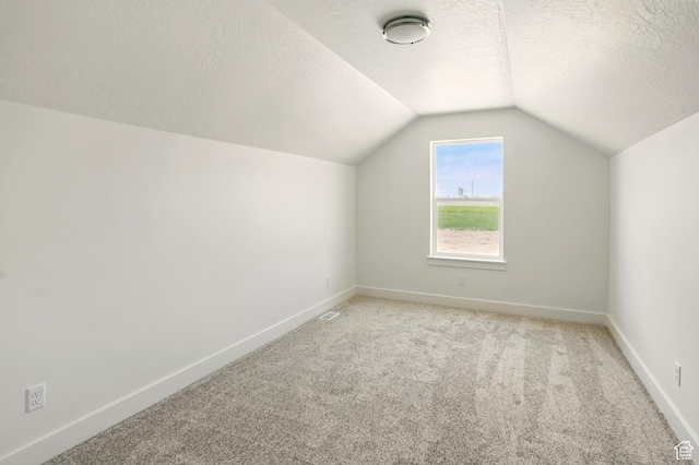 1154 E 1150 S, Garland, UT 84312 - additional living space with vaulted ceiling, light carpet, and a textured ceiling