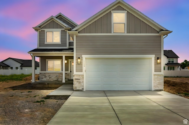 1154 E 1150 S, Garland, UT 84312 - craftsman-style home featuring stone siding, board and batten siding, a porch, concrete driveway, and an attached garage