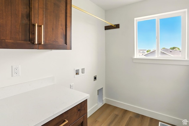 1154 E 1150 S, Garland, UT 84312 - laundry room with hookup for an electric dryer, hookup for a washing machine, cabinet space, and wood finished floors